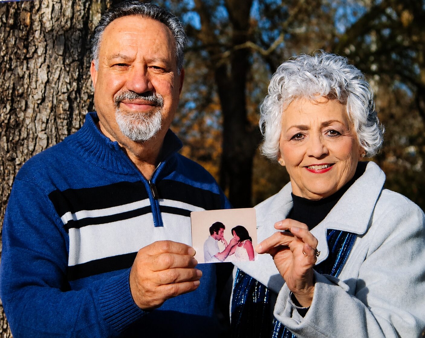 Walid and his wife holding a photo from decades ago