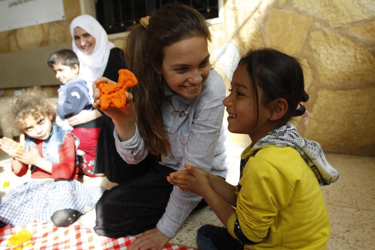 A volunteer sharing a craft activity with children